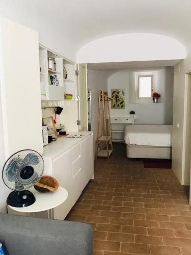 a room with a room with a bed and a fan at Casa da Travessa in Évora
