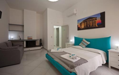 a bedroom with a large bed and a couch at La terrazza dei tramonti in Capaccio-Paestum