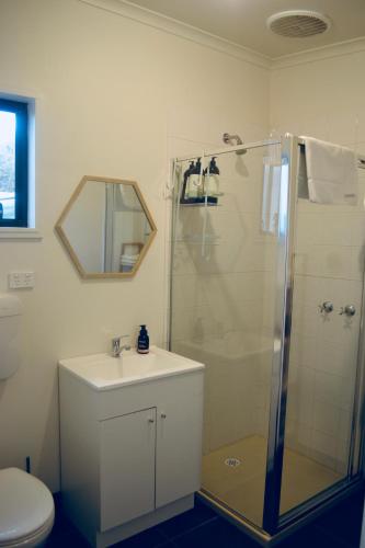 a bathroom with a shower and a sink and a toilet at Bower On Becket - Couples Retreat in Rye