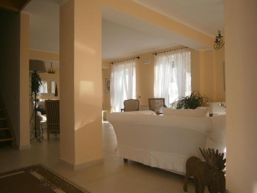 a living room with a large white couch in a room at Residenza Don Agostino in Vallo della Lucania