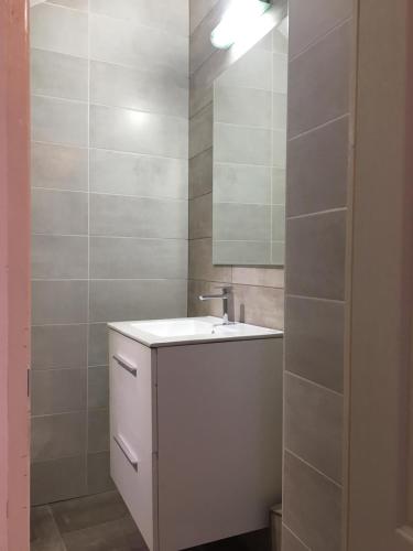 a bathroom with a white sink and a mirror at BrasovApart Piata Sfatului 2 in Braşov