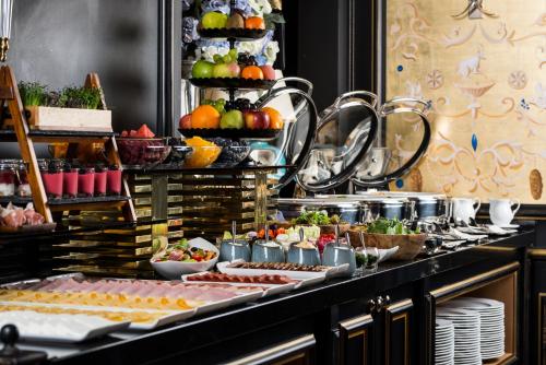 a buffet of food with fruits and vegetables on display at Bachleda Luxury Hotel Kraków - MGallery Collection in Kraków
