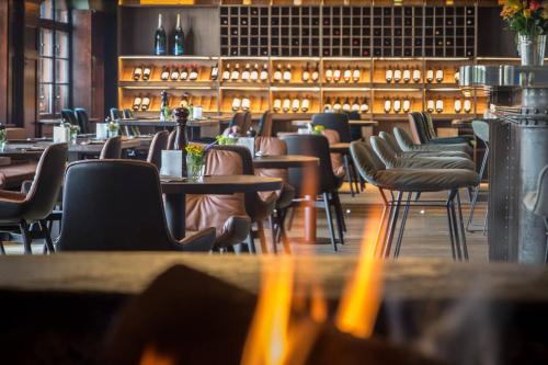 a restaurant with tables and chairs and a bar at Wailtl Hotel in Dorfen