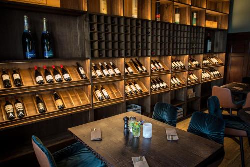 a dining room with a table and lots of wine bottles at Wailtl Hotel in Dorfen