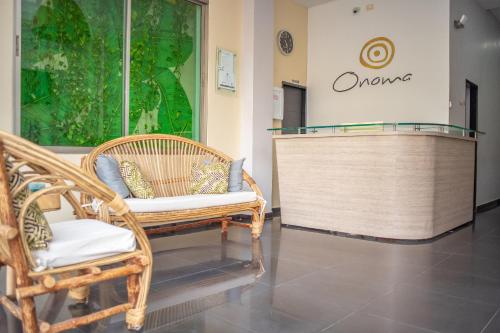 a living room filled with furniture and a walk in shower at Onoma Hotel in Lorica