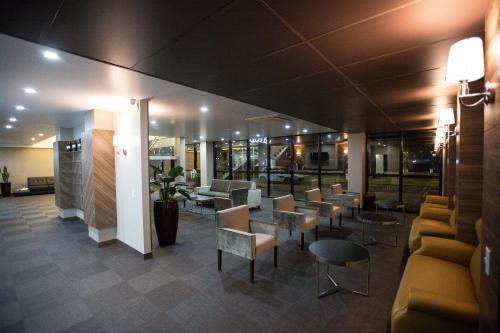 a lobby of a hospital with chairs and tables at Bello Hotel in Toledo