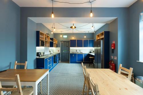 a kitchen with blue cabinets and a wooden table at The Warren Belfast in Belfast