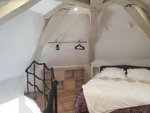 a bedroom with a bed in an attic at Tour de Lacuzon in Dole