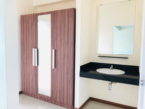 a bathroom with a sink and a mirror at My Room in Ratchaburi