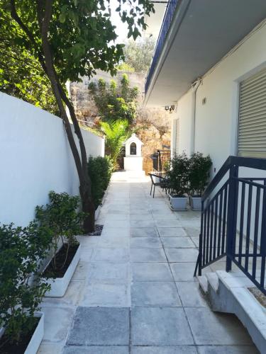 a walkway outside a house with a tree and a building at Villa Teo in Kalamata