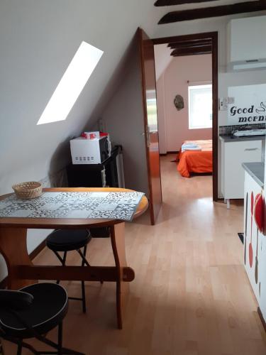 a dining room with a table and chairs in a room at Studio in Pontacq