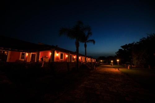 a house at night with a palm tree next to it at Agriturismo Masseria Sant' Elia in Arenella