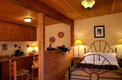 a kitchen and a bedroom with a bed in a room at The Maverick Inn in Alpine