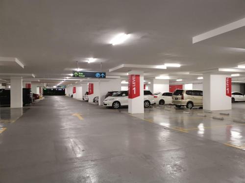 an empty parking garage with cars parked in it at Grand Medini Suites by RR JBcity in Nusajaya