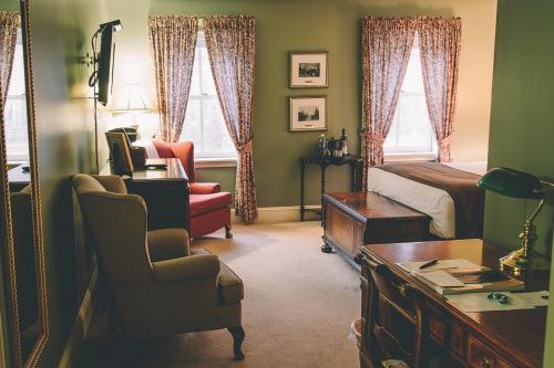 a living room filled with furniture and a window at The Great George in Charlottetown