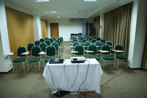 a room full of chairs and a table with a white table sidx sidx at Garbos Trade Hotel in Mossoró