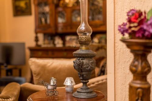 a lamp on a table in a living room at Lia's Guest House in Tbilisi City