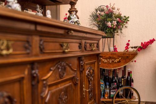 a wooden cabinet with bottles of wine on it at Lia's Guest House in Tbilisi City
