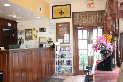 a shop with a cash counter and flowers on the wall at The Prytania Park Hotel in New Orleans