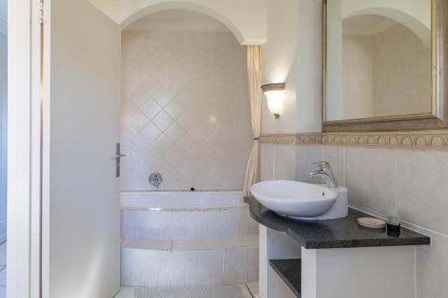 a bathroom with a sink and a bath tub at Castleton Unit 73 Plettenberg Bay in Plettenberg Bay