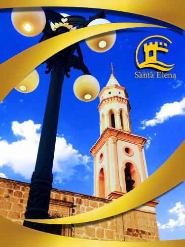 a building with a clock tower in the background at Hotel Santa Elena in El Fuerte