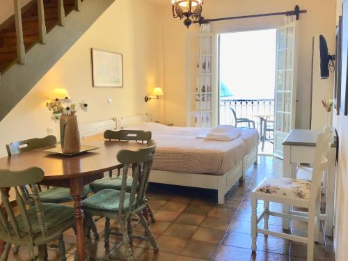 a bedroom with a bed and a table and chairs at Linardos Apartments in Asos
