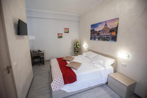 a bedroom with a white bed with a red blanket at Rooms Monteverde 2 in Rome