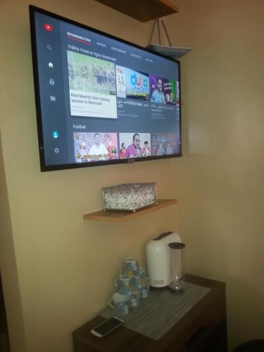 a flat screen tv hanging on a wall in a hotel room at Nice appartement à Marrakech in Marrakesh