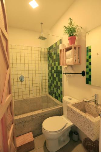 a bathroom with a toilet and a shower and a sink at Casa Morelos by Barrio Mexico in Guadalajara