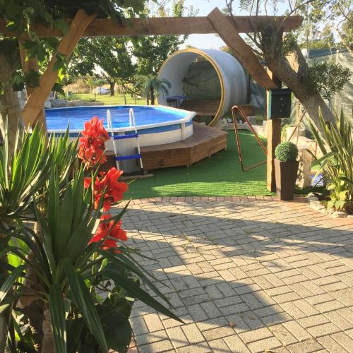 a backyard with a swimming pool and a tent at Quinta Forum in Tocha
