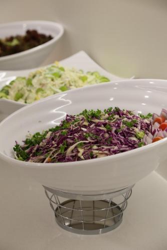 a salad in a white bowl on a table at ASTORIA Hotel & Medical Spa in Karlovy Vary