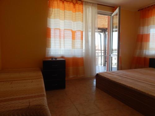 a bedroom with two beds and a window at Dunav Apt.3 in Ravda