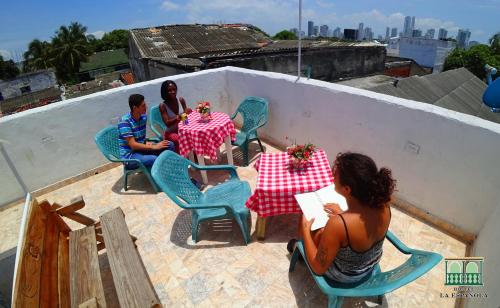 a group of people sitting at tables on a roof at Hostal La Española de Getsemani in Cartagena de Indias