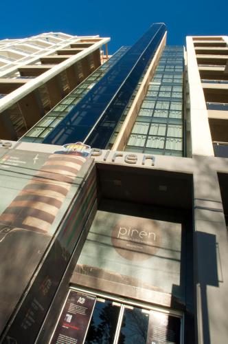a tall building with a pazon sign on it at Hotel Piren in Puerto Madryn