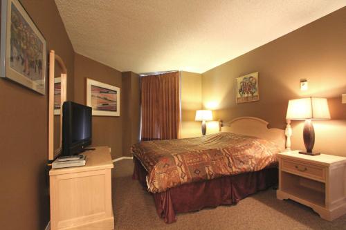 a hotel room with a bed and a flat screen tv at Marquise Condos by Whistler Retreats in Whistler