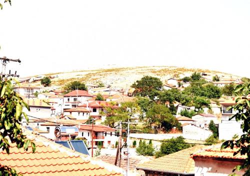 a view of a town with houses and roofs at Stavroula's Houses in Kélla