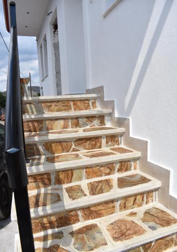 a set of stairs leading up to a house at Stavroula's Houses in Kélla