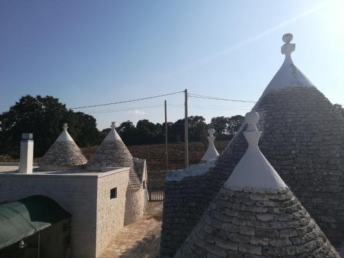 a group of roofs on top of a building at Trullo Le Tre Sorelle in Cisternino