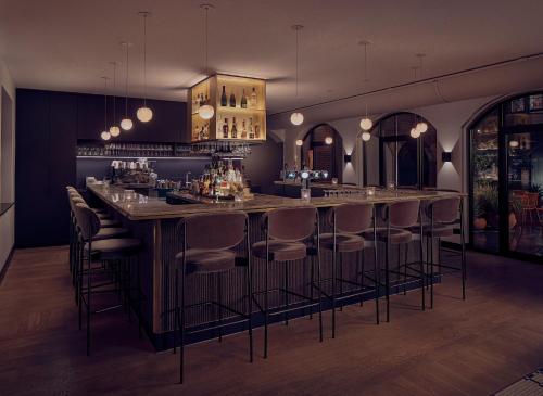 a bar with bar stools in a room at The Anthony in Utrecht