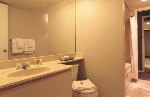 a bathroom with a sink and a toilet and a mirror at Marquise Condos by Whistler Retreats in Whistler