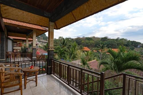 a balcony with a view of the jungle at Breeze Villa in Nusa Lembongan