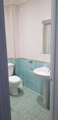 a bathroom with a toilet and a sink at Golders Park Hotel in London