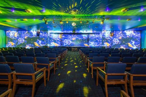 an empty room with chairs and a large aquarium at Dreams Jade Resort & Spa - All Inclusive in Puerto Morelos