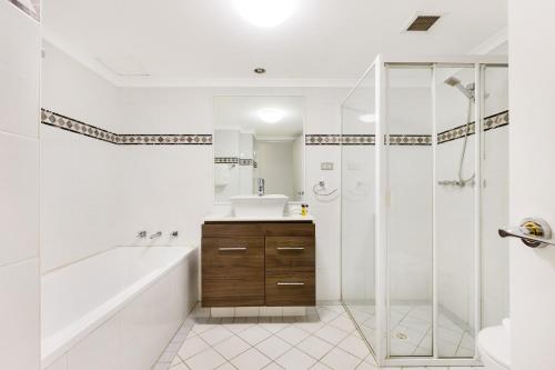 a bathroom with a tub and a shower and a sink at Inner city retreat in Pyrmont 1 bdrm with Car space - 28 Mill in Sydney