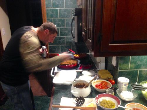 a man standing in a kitchen preparing food at Jacaranda in Milton