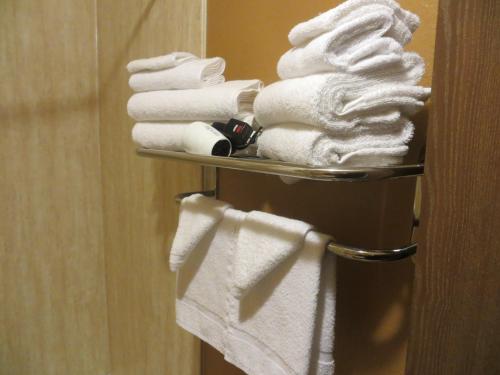 a pile of towels on a towel rack in a bathroom at Old Town Inn in Crested Butte