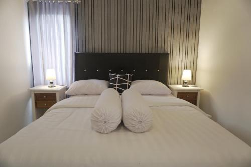 a bedroom with two white pillows on a bed at Sayana Homestay in Sleman
