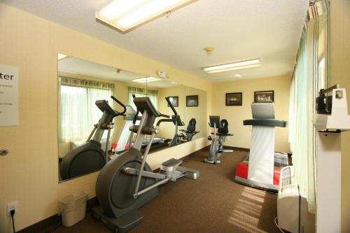 a gym with several tread machines in a room at Country Inn & Suites by Radisson, Shelby, NC in Shelby