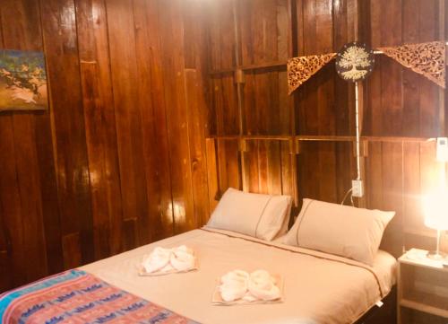 a bedroom with a bed with two towels on it at Songthai Suvarnabhumi in Ban Khlong Si