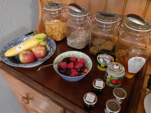 a table with jars of food and fruit on it at Glenelg in Tobermory